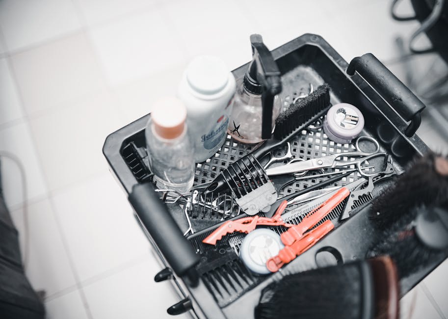 A selection of hairdressing tools and products arranged in a salon trolley for professional use.
